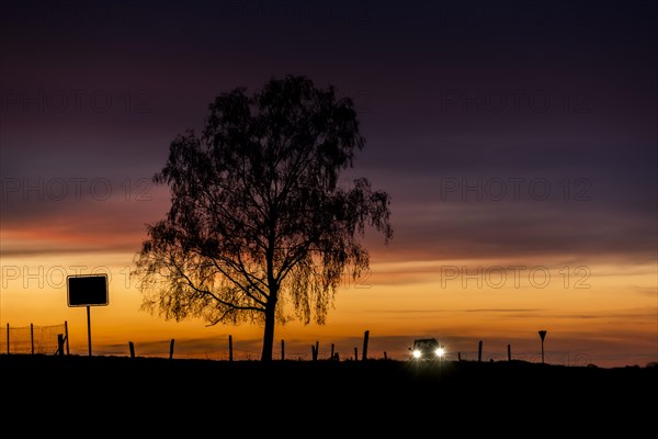 A car stands out in the evening twilight near Ober-Prauske