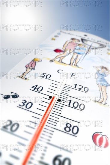 Worm's-eye view of thermometer measures extremely hot temperature of 40 degrees Celsius
