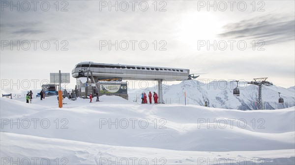 Moosfluh gondola station and Swiss ski instructors gathering on top of ski slope near the Aletsch Glacier in winter