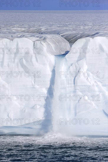 Waterfall at edge of the Brasvellbreen glacier from the ice cap Austfonna debouching into the Barents Sea