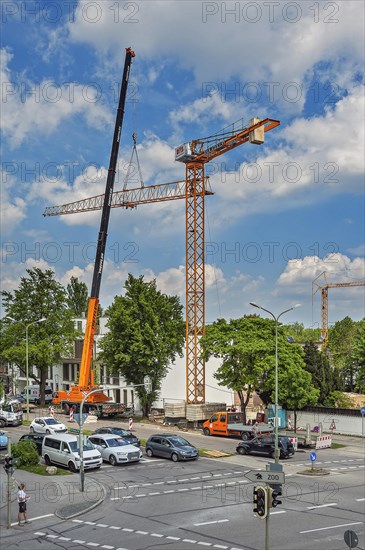 A construction crane is erected with a truck-mounted crane