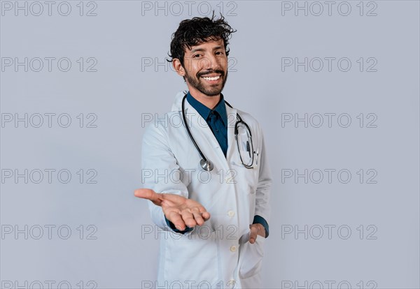 Smiling doctor extending hand in welcome. Young doctor extending hand to camera