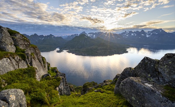 Sun star at sunset over the mountain peaks