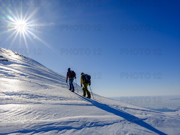 Climbers climb over ice on the local mountain