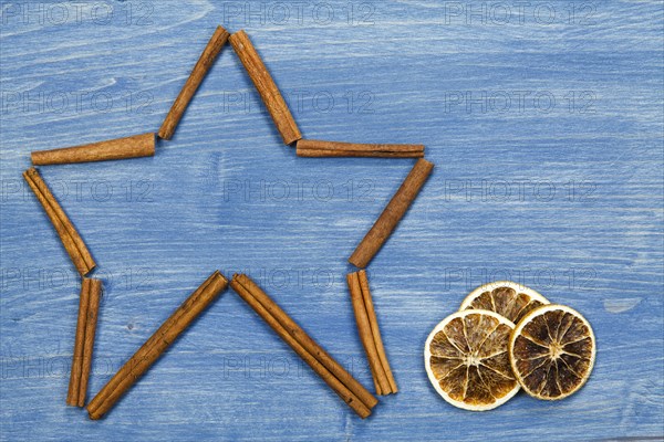 Star of cinnamon sticks on a blue background