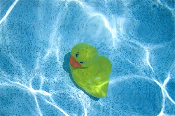Yellow rubber duck at the bottom of pool