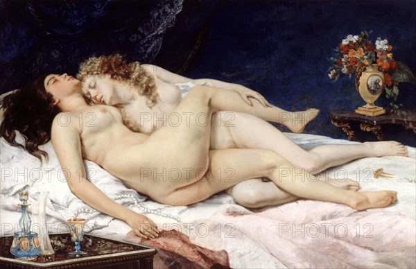 Two naked woman in a bed