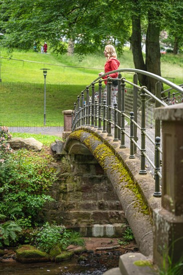 Woman standing on historic bridge