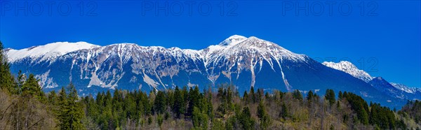 Snow-covered Alps behind Lake Bled