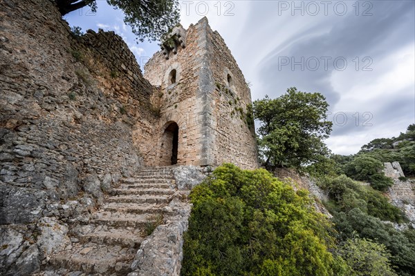 Stone steps and tower of the castle ruins Castell Alaro