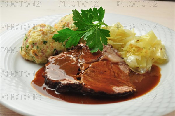 Roast beef with bread dumplings and white cabbage