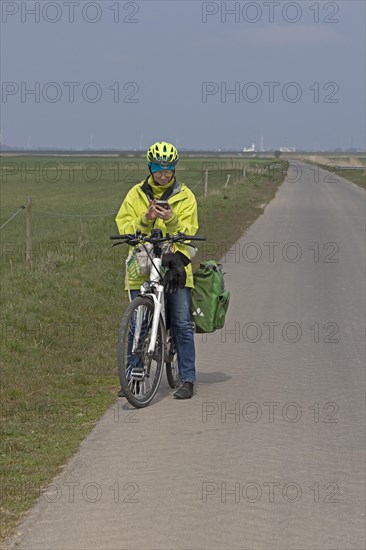 Cyclist checking her mobile phone