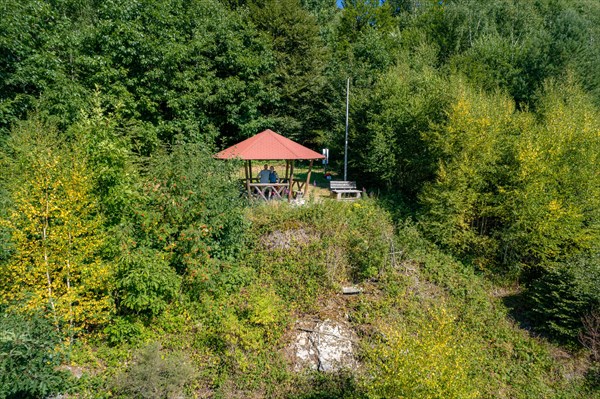 Hiking couple in wooden pavilion on the hiking trail Sprollenhaeuser Hut