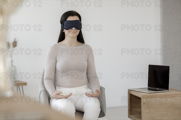 Woman sitting on chair and doing a relaxation exerciseg