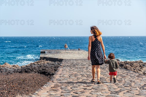 Mother and son at the pier in Orchilla on the southwest coast of El Hierro. Canary Islands