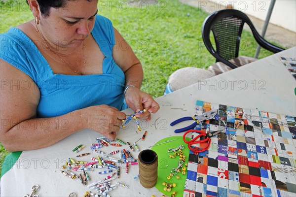 Costa Rican woman makes key rings from old newspapers