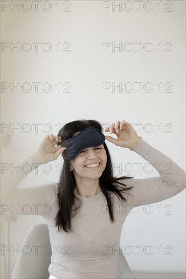 Happy woman with eye mask