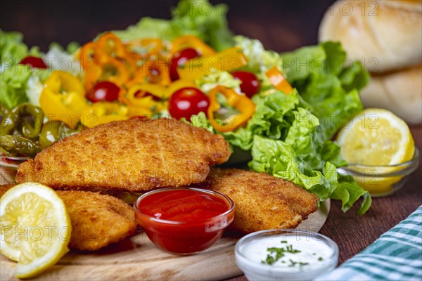 Vegan schnitzel with sauces and salad