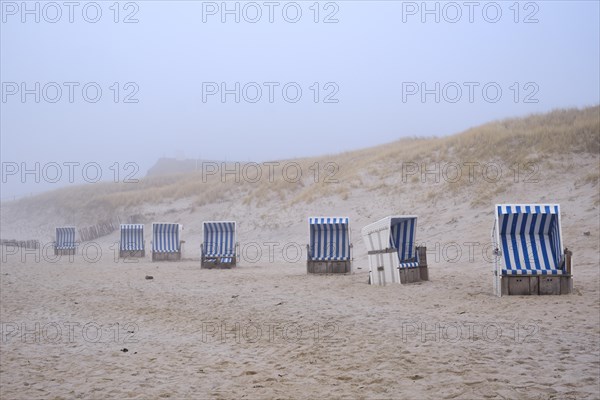 Empty beach chairs on a sandy beach