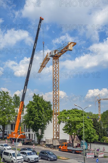 A construction crane is erected with a truck-mounted crane