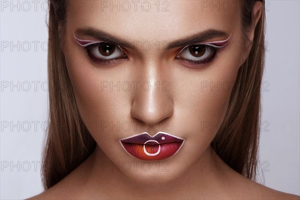 Beautiful caucasian woman with creative makeup and purple lips. Beauty face. Art makeup