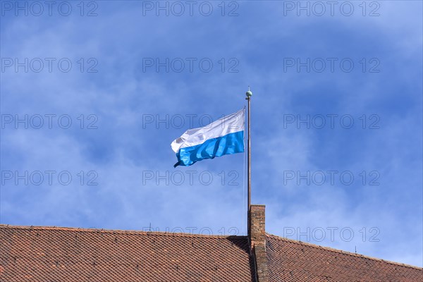 Waving Bavarian flag on the roof of the Kaiserburg