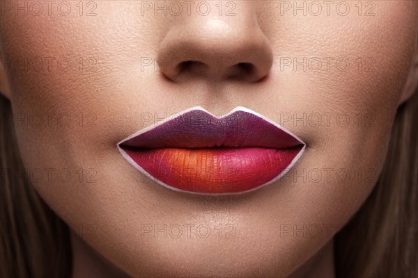 Beautiful caucasian woman with creative makeup and purple lips. Beauty face. Art makeup