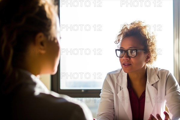 A doctor in a white coat talking to a patient