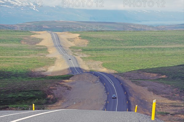 Very undulating road runs through barren landscapes