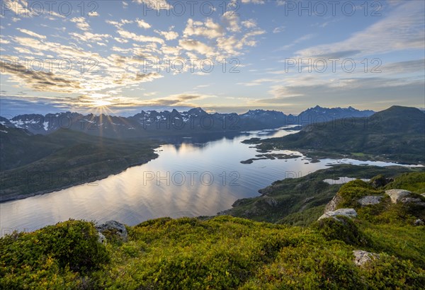 Sun star at sunset over the mountain peaks