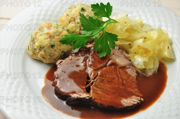 Roast beef with bread dumplings and white cabbage