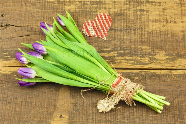 Bouquet of Tulips on Wooden Background and Heart