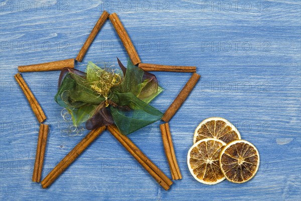 Star of cinnamon sticks on a blue background