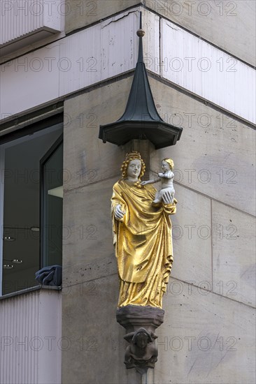 Coloured sculpture of Mary with the Child on a residential house