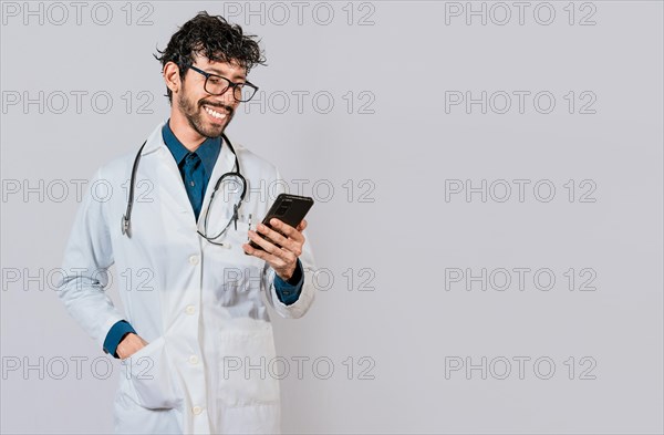 Young doctor with phone isolated