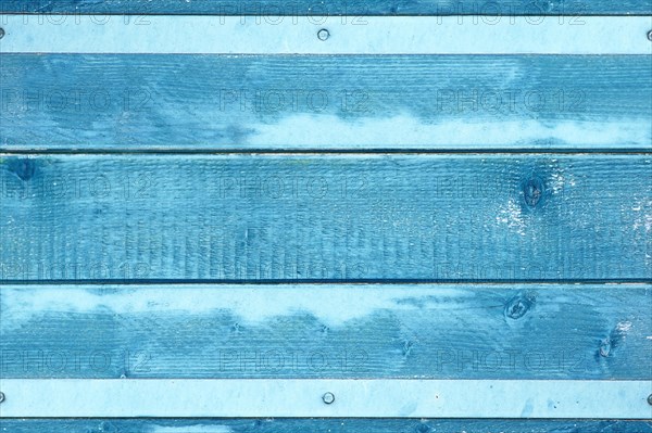 Wooden background with blue colored planks