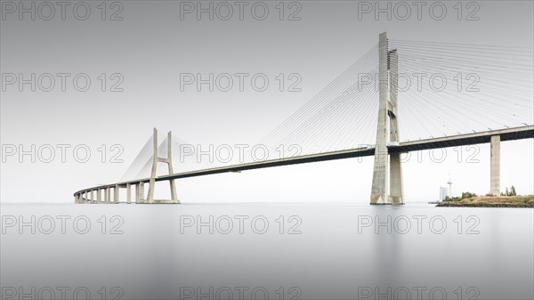 Minimalist long exposure of the famous Ponte Vasco da Gama bridge over the Tagus in Lisbon