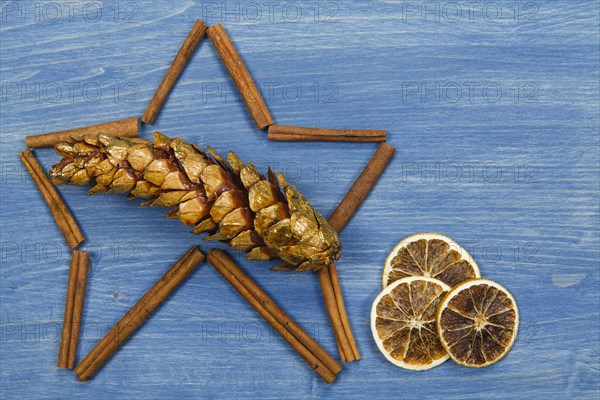 Star of cinnamon sticks on a blue background