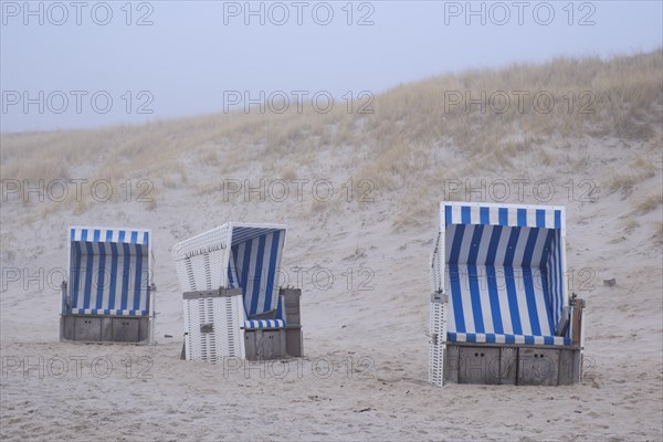 Empty beach chairs on a sandy beach