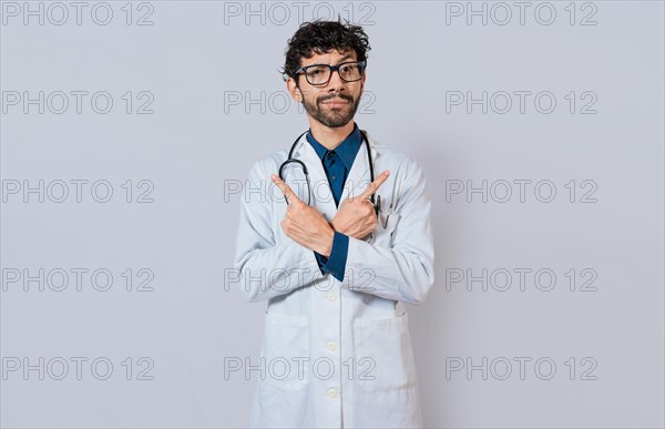 Doctor pointing to both sides isolated. Bearded doctor pointing to both sides on isolated background. Doctor pointing at an advertising space with both hands