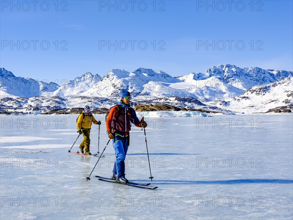 Ski mountaineers cross the frozen Kong Oscar Fjord