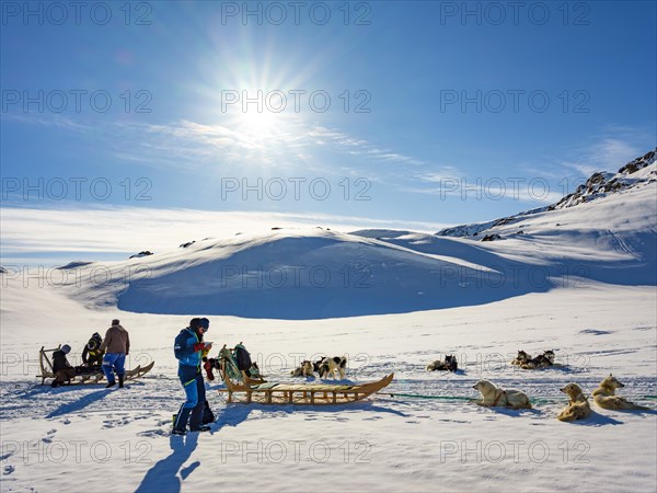 Inuit with their dog sled teams and ski tourers