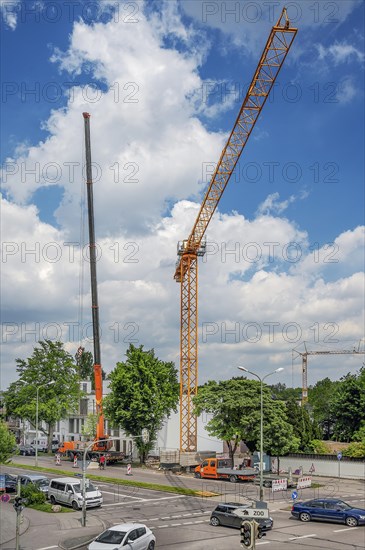 A construction crane is erected with a truck-mounted crane