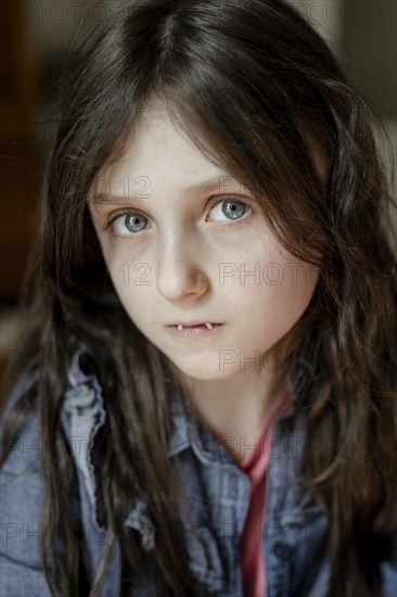 Girl with false vampire teeth