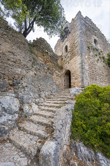 Stone steps and tower of the castle ruins Castell Alaro