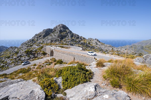 Car at the mountain pass with switchbacks to Sa Colobra