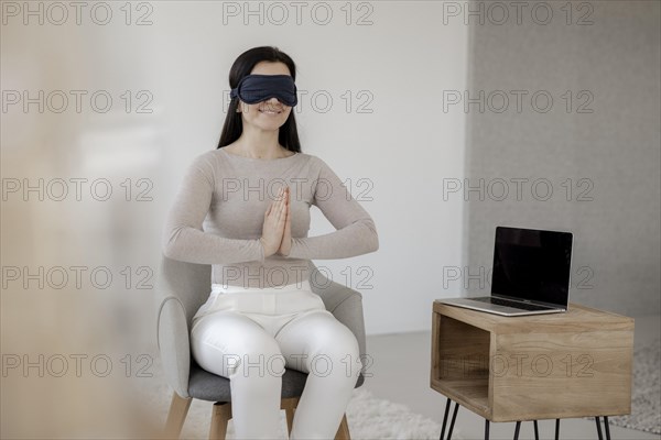 Woman sitting on chair doing a relaxation exercise