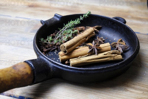 Cinnamon sticks and star anise in a pan