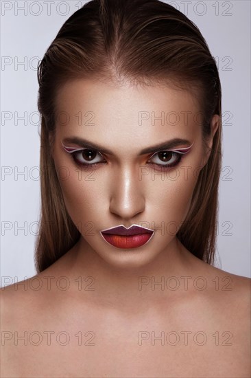 Beautiful caucasian woman with creative makeup and purple lips. Beauty face. Art makeup