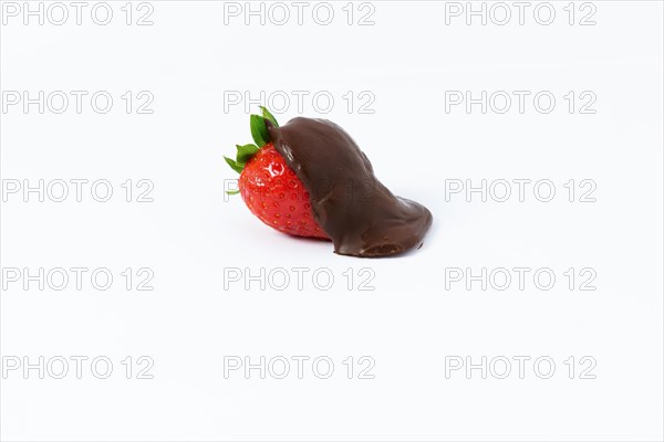 Strawberry covered with melted chocolate isolated on white background